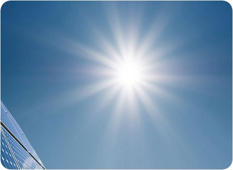 4 solar panels with bright sun in background
