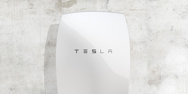 tesla powerwall battery mounted on concrete wall