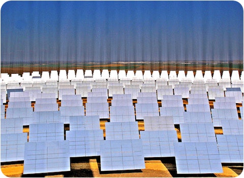 solar farm showing beams of light shining into the sky