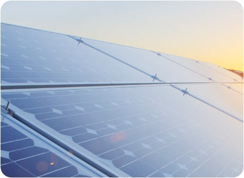 9 solar panels on tile roof at sunset